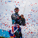 A photo of Sam Bird spraying champagne on the Formula E podium.